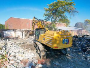 R.E.D. excavator with demolition attachment working on a commercial site in Western New York